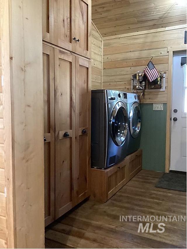 1000 Pardee Road Kamiah, ID 83536 - Photo 34 of 50 Utility area featuring wood-finish flooring, natural wood paneled walls, and built-in wood cabinetry with dark hardware