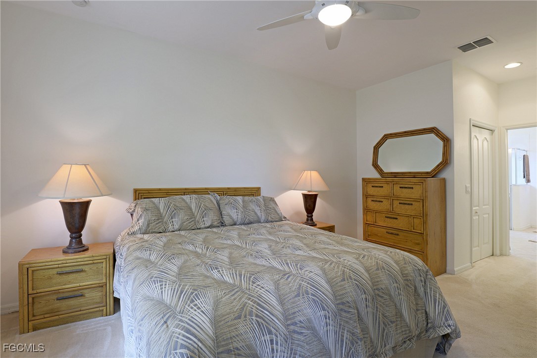 13225 Silver Thorn Loop, Unit 304 North Fort Myers, FL 33903 - Photo 15 of 27 a bedroom with a bed and a lamp