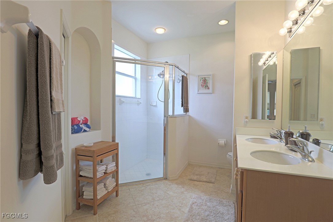 13225 Silver Thorn Loop, Unit 304 North Fort Myers, FL 33903 - Photo 16 of 27 a bathroom with a shower sink and mirror