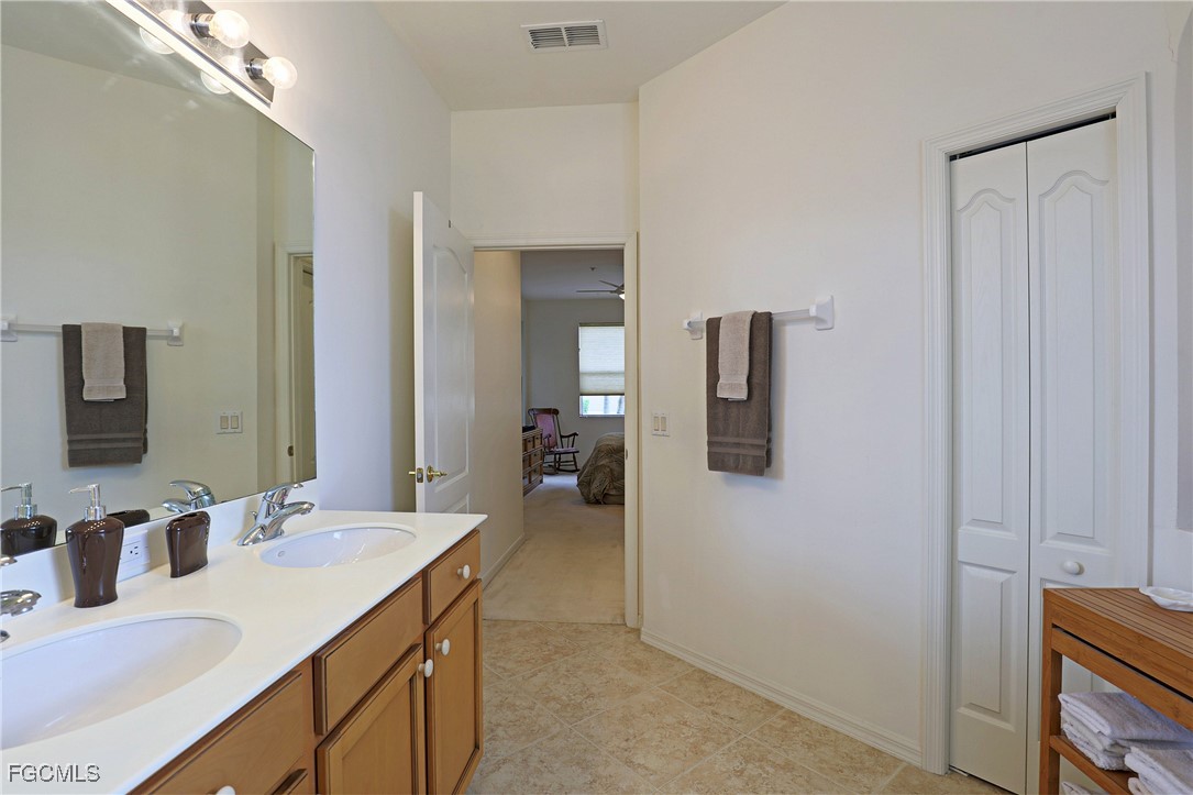 13225 Silver Thorn Loop, Unit 304 North Fort Myers, FL 33903 - Photo 17 of 27 a en suite bathroom with a granite countertop sink and mirror