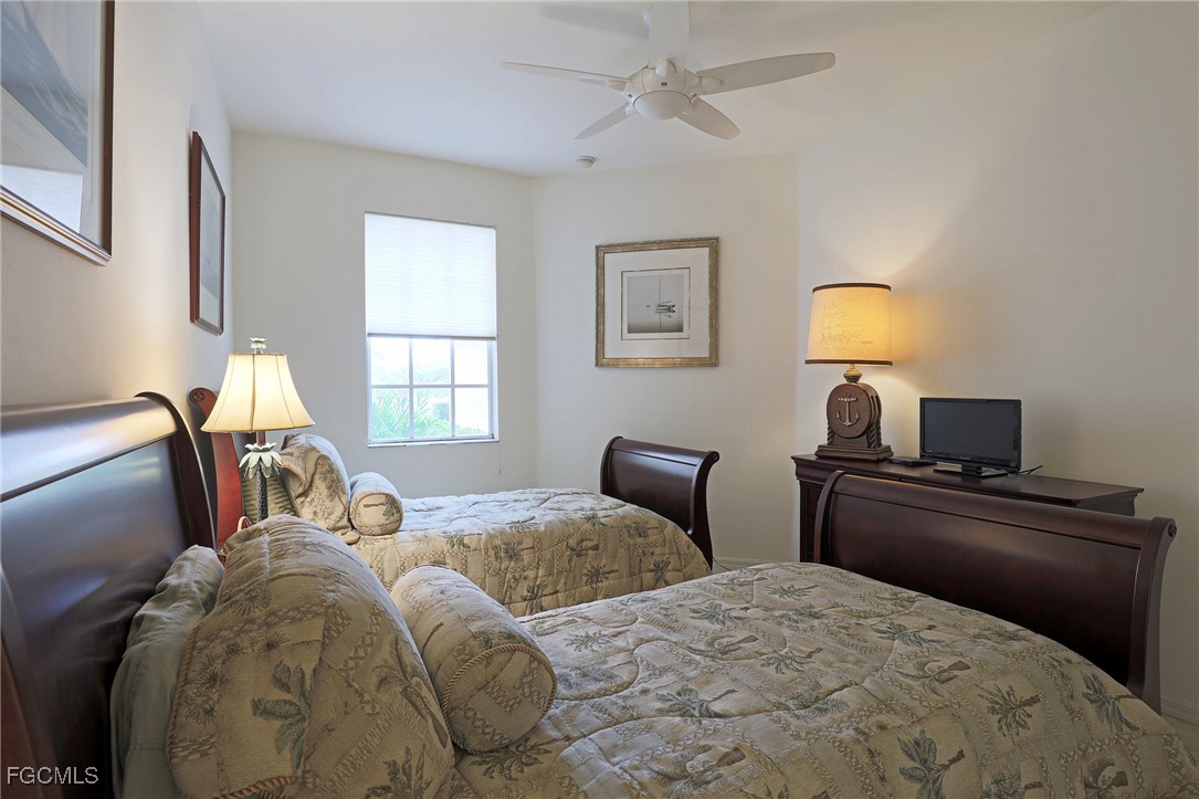 13225 Silver Thorn Loop, Unit 304 North Fort Myers, FL 33903 - Photo 18 of 27 a bedroom with two beds and a window