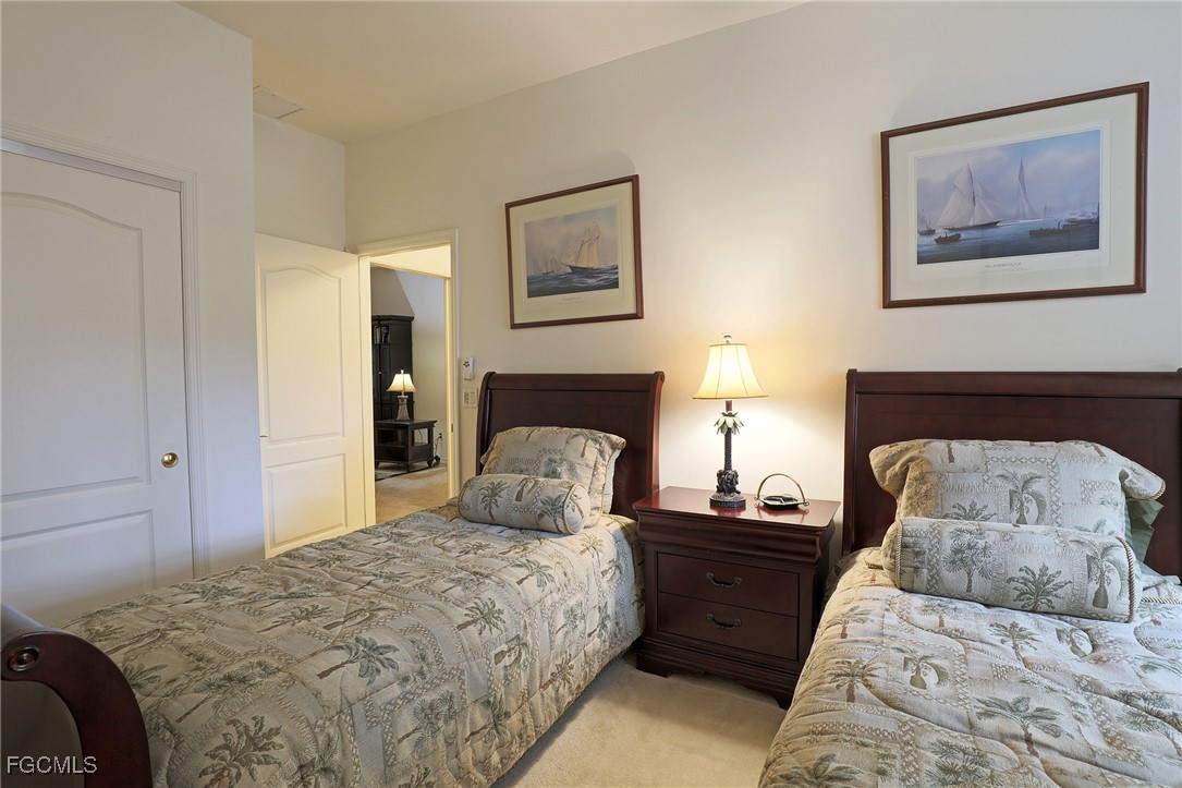 13225 Silver Thorn Loop, Unit 304 North Fort Myers, FL 33903 - Photo 19 of 27 a bedroom with bed and wooden floor