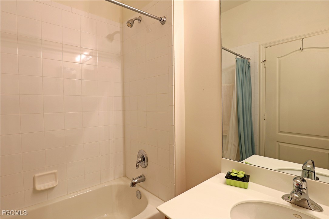 13225 Silver Thorn Loop, Unit 304 North Fort Myers, FL 33903 - Photo 20 of 27 a bathroom with a sink and a mirror