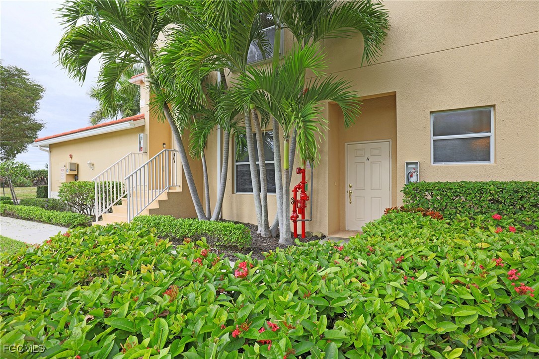 13225 Silver Thorn Loop, Unit 304 North Fort Myers, FL 33903 - Photo 2 of 27 a plant is in front of a house