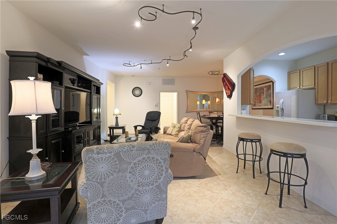 13225 Silver Thorn Loop, Unit 304 North Fort Myers, FL 33903 - Photo 4 of 27 a living room with fireplace furniture and a flat screen tv