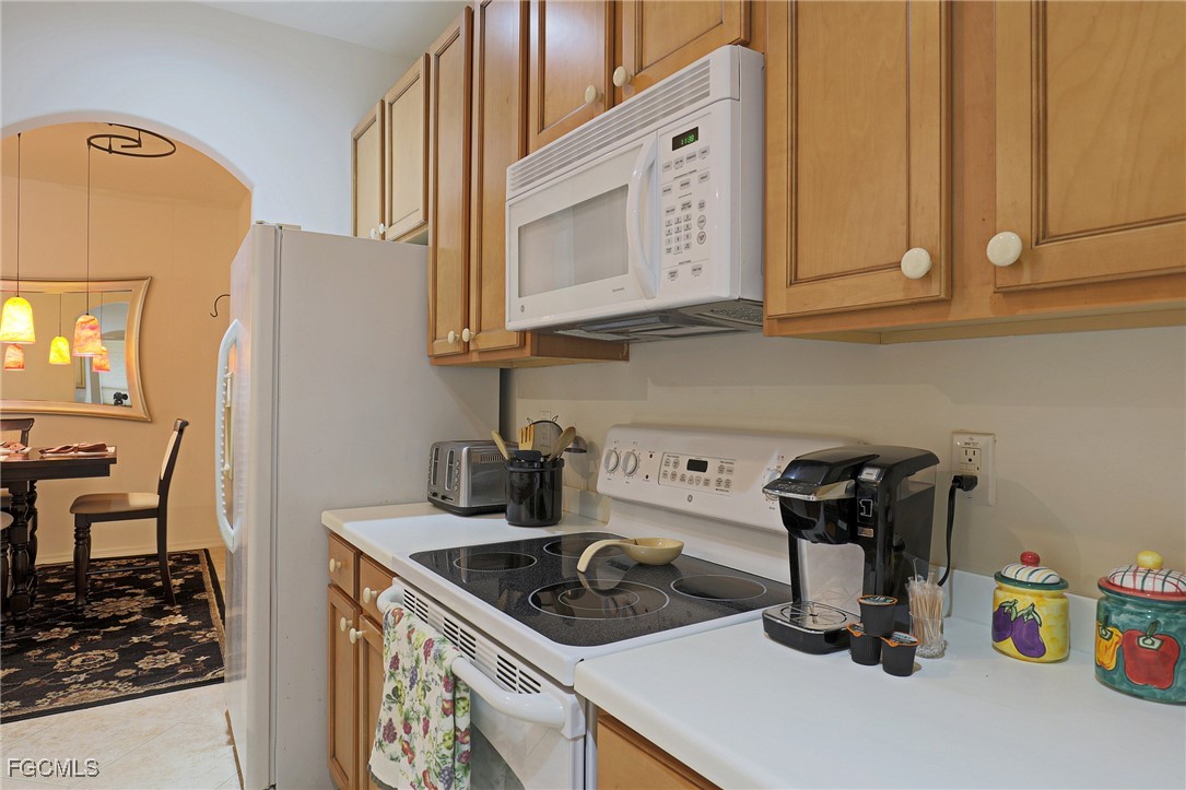 13225 Silver Thorn Loop, Unit 304 North Fort Myers, FL 33903 - Photo 7 of 27 a kitchen with a sink stove and cabinets