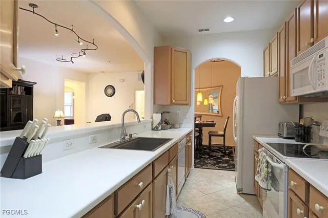 a kitchen with a sink stove and cabinets
