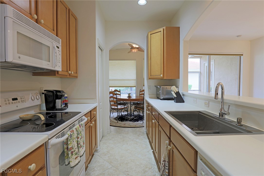 13225 Silver Thorn Loop, Unit 304 North Fort Myers, FL 33903 - Photo 9 of 27 a kitchen that has a sink and a stove