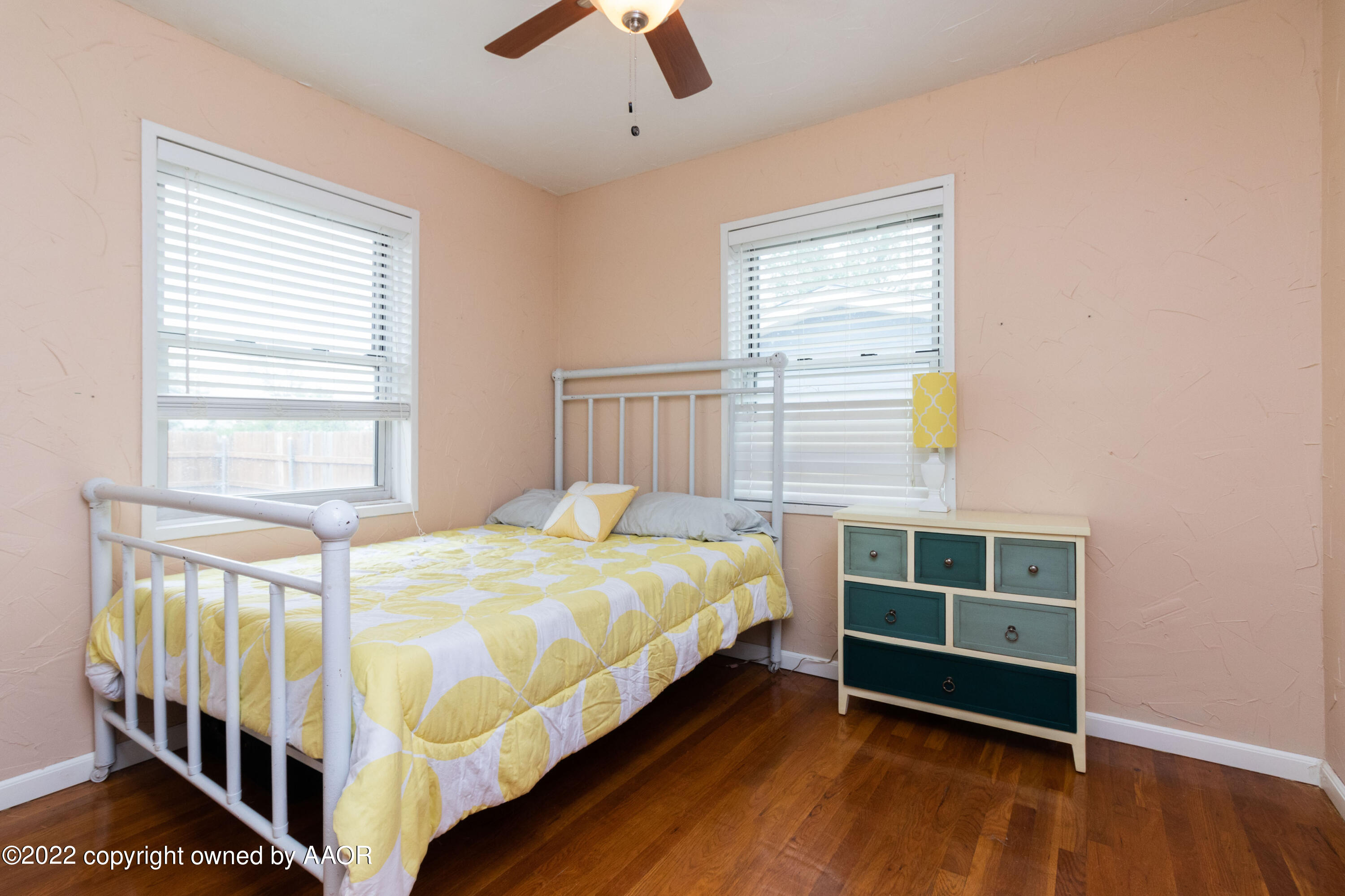4633 South Hayden Street Amarillo, TX 79110 - Photo 13 of 20 a bed sitting in a bedroom next to a window