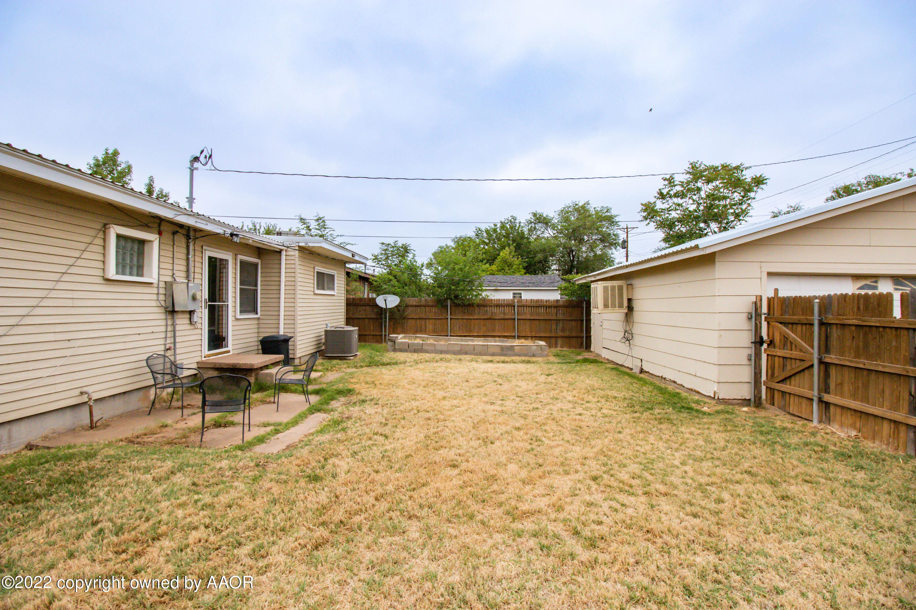 4633 South Hayden Street Amarillo, TX 79110 - Photo 18 of 20 a backyard of a house with table and chairs