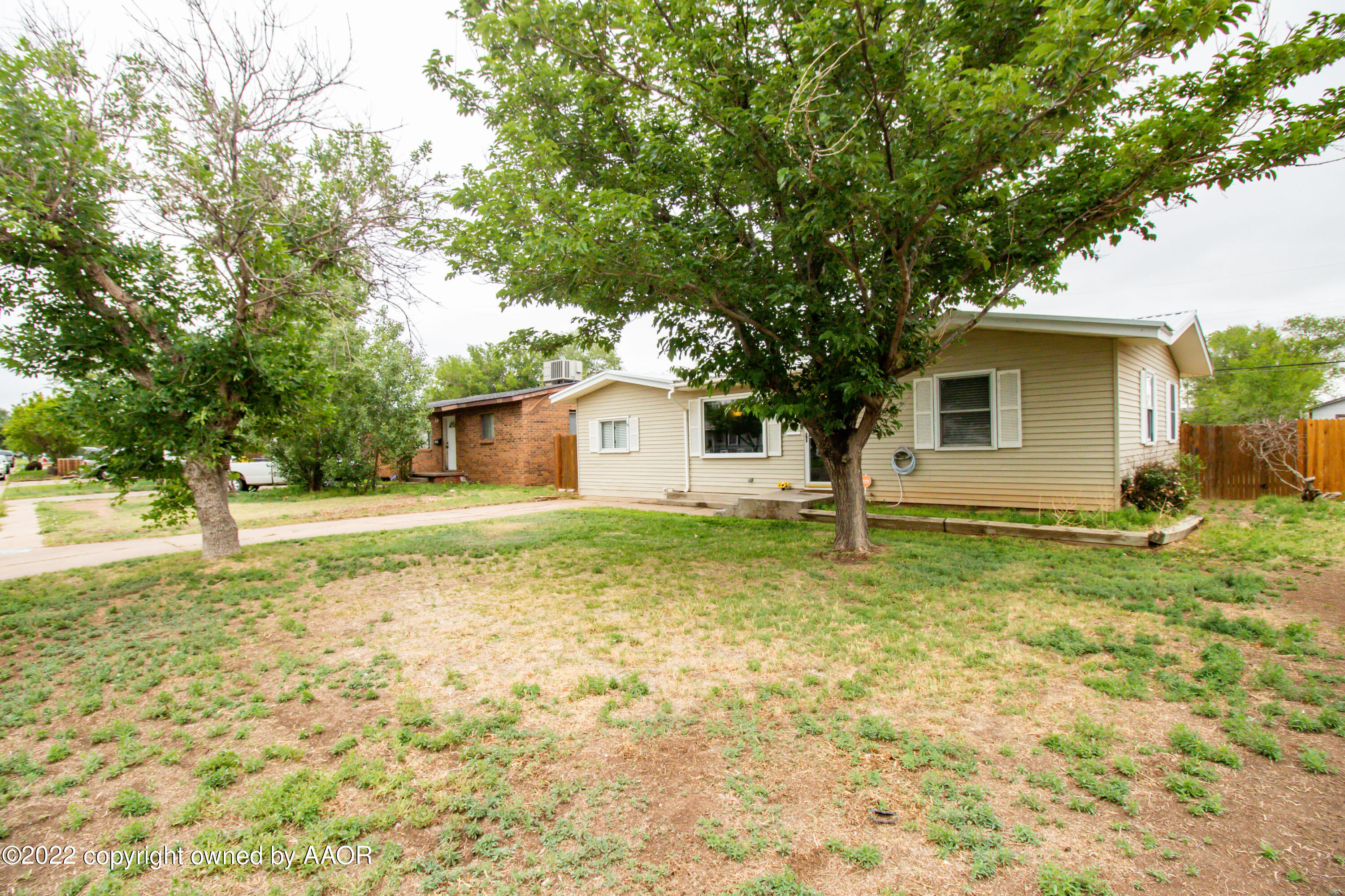 4633 South Hayden Street Amarillo, TX 79110 - Photo 3 of 20 a view of a house with backyard and tree