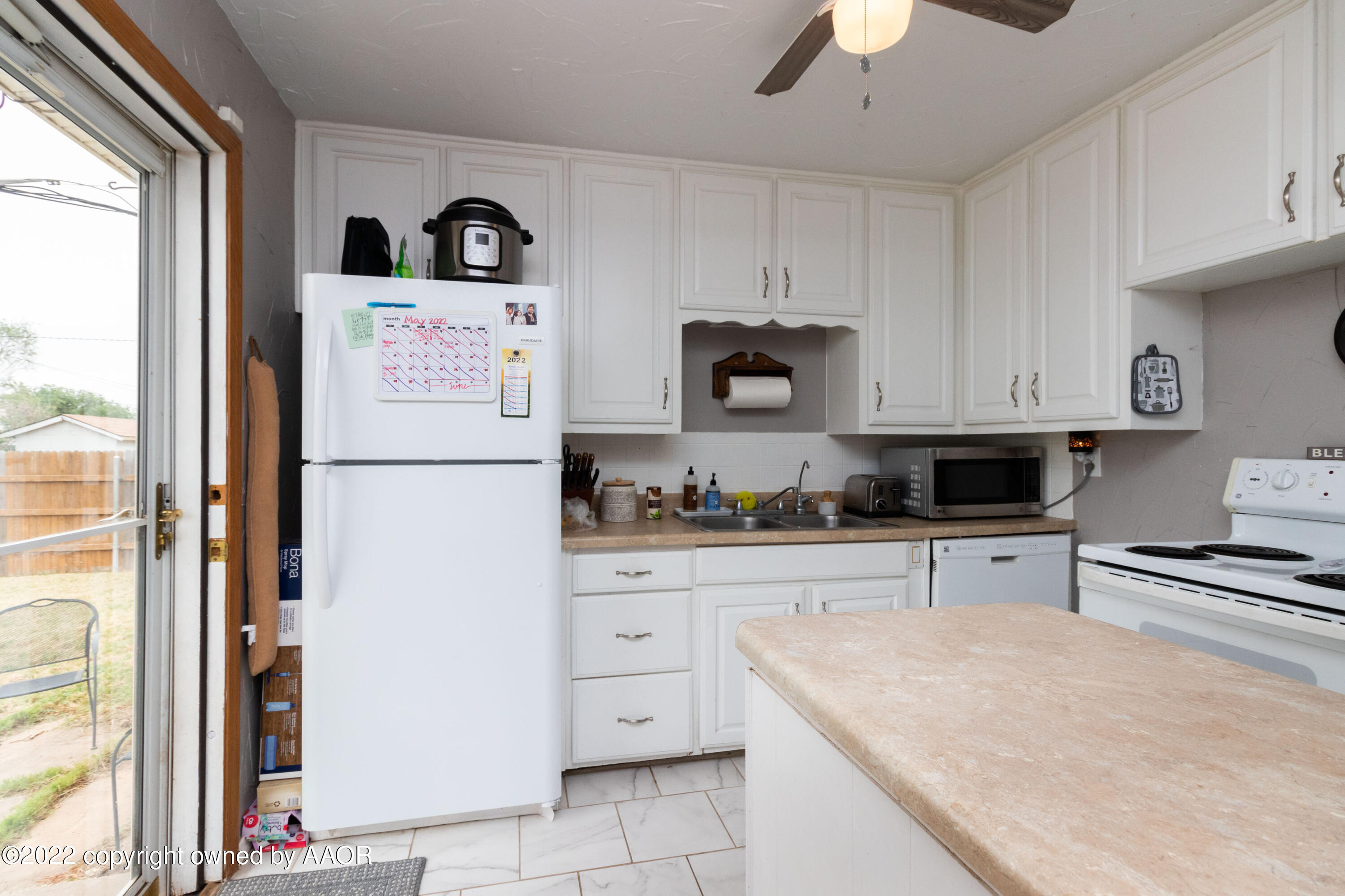 4633 South Hayden Street Amarillo, TX 79110 - Photo 7 of 20 a kitchen with cabinets appliances and a window