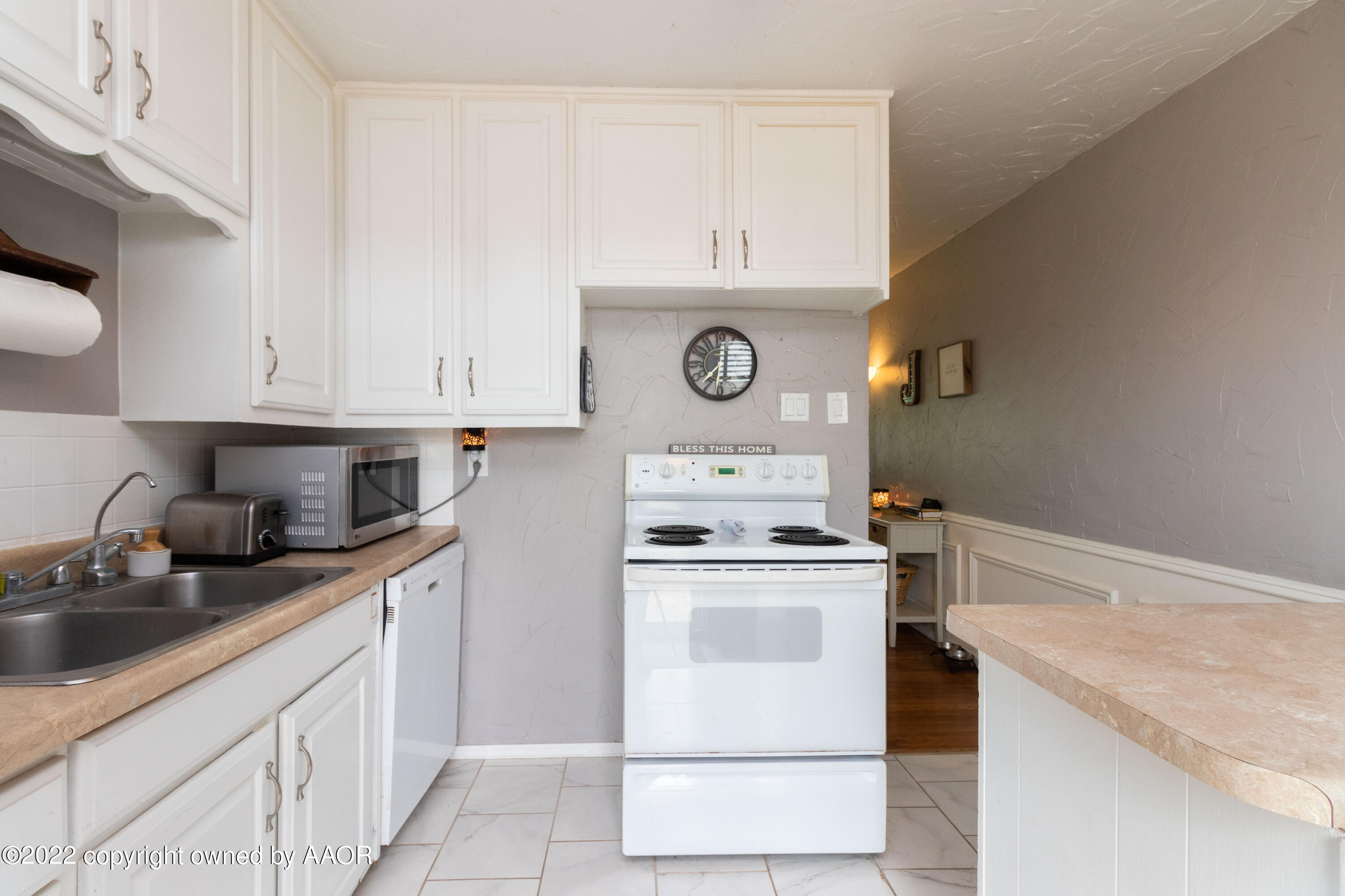 4633 South Hayden Street Amarillo, TX 79110 - Photo 8 of 20 a kitchen with stainless steel appliances granite countertop a sink and a stove