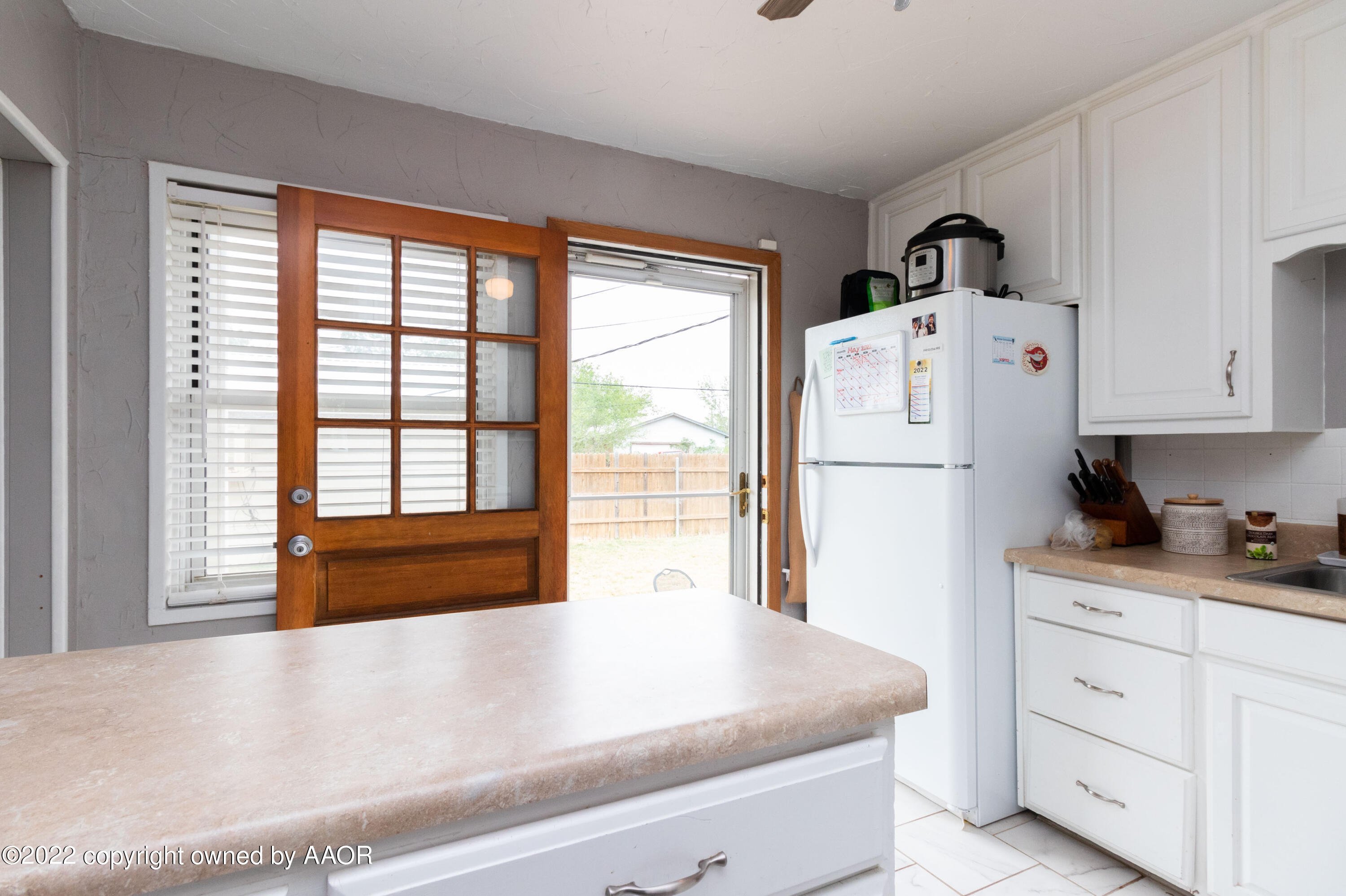 4633 South Hayden Street Amarillo, TX 79110 - Photo 9 of 20 a kitchen with refrigerator and window