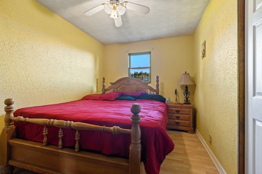 19948 West Mississippi Road Elwood, IL 60421 - Photo 5 of 12 a bedroom with a bed and a chandelier