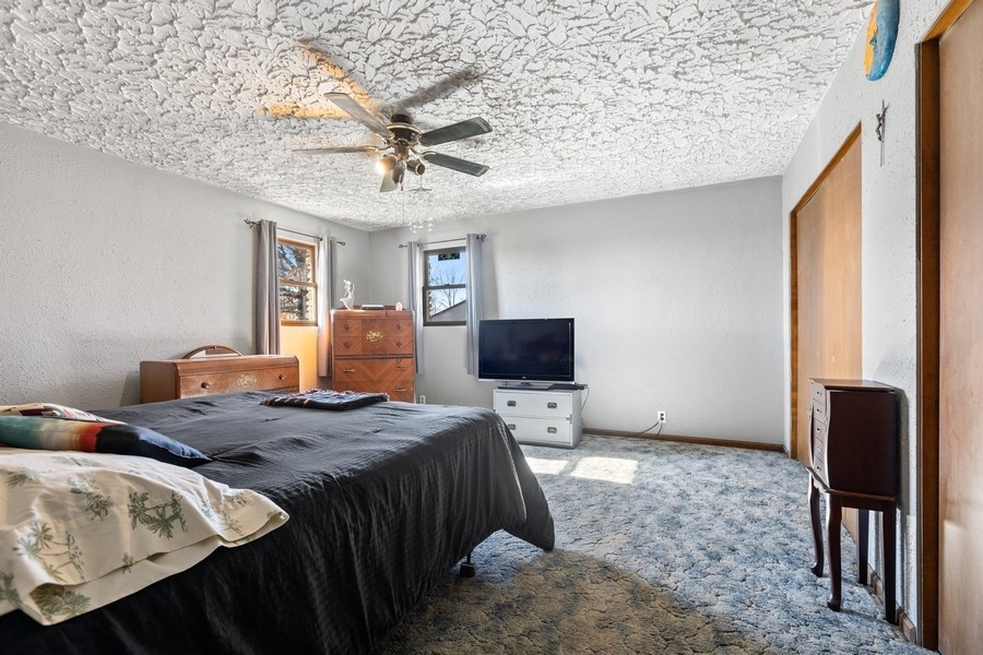 19948 West Mississippi Road Elwood, IL 60421 - Photo 6 of 12 a bedroom with a bed and wooden floor