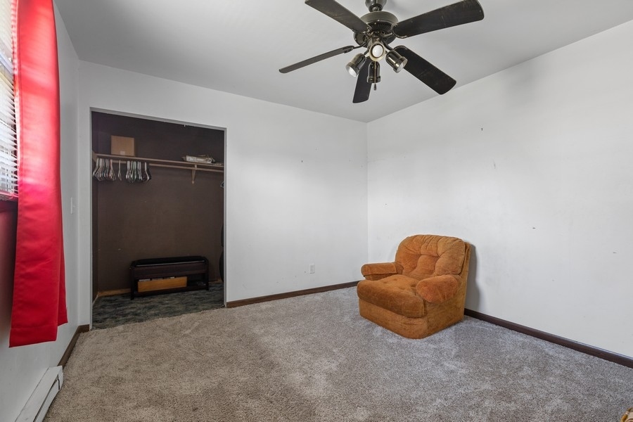 19948 West Mississippi Road Elwood, IL 60421 - Photo 8 of 12 an empty room with closet and ceiling fan