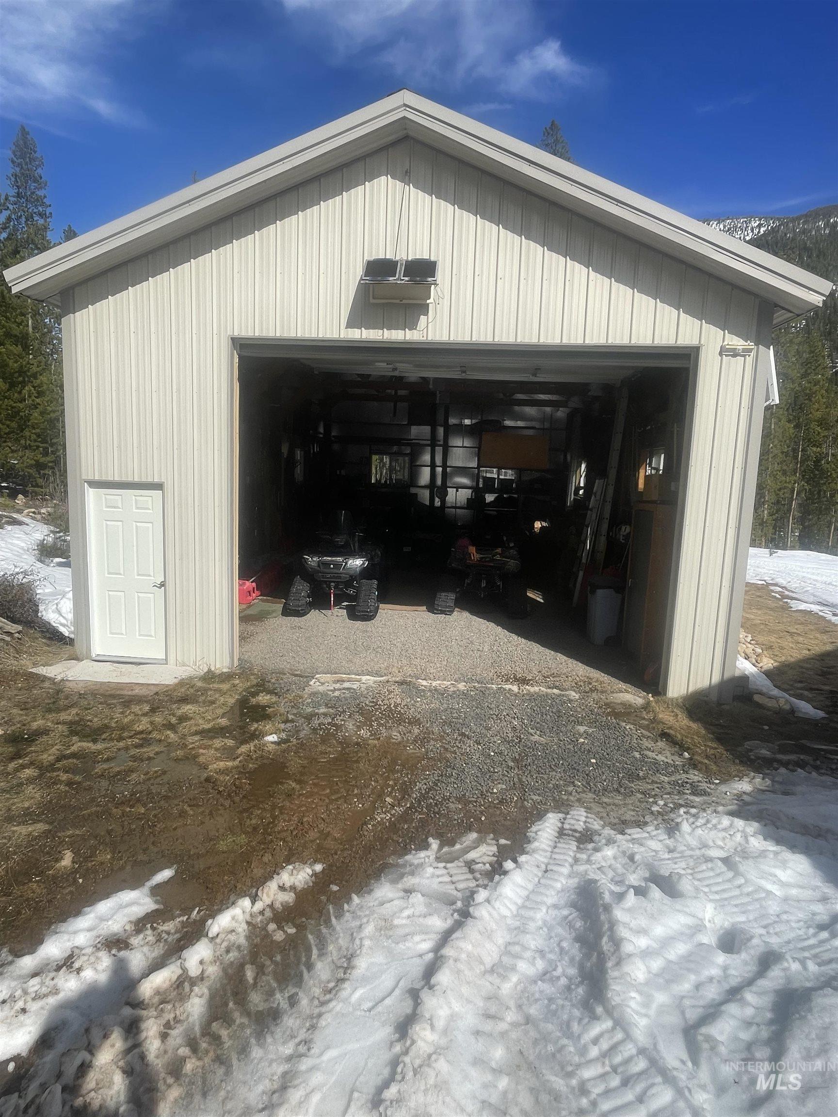 17567 Edwardsburg Road Yellow Pine, ID 83677 - Photo 3 of 11 Metal-sided detached garage with a single vehicle bay and an additional pedestrian entry