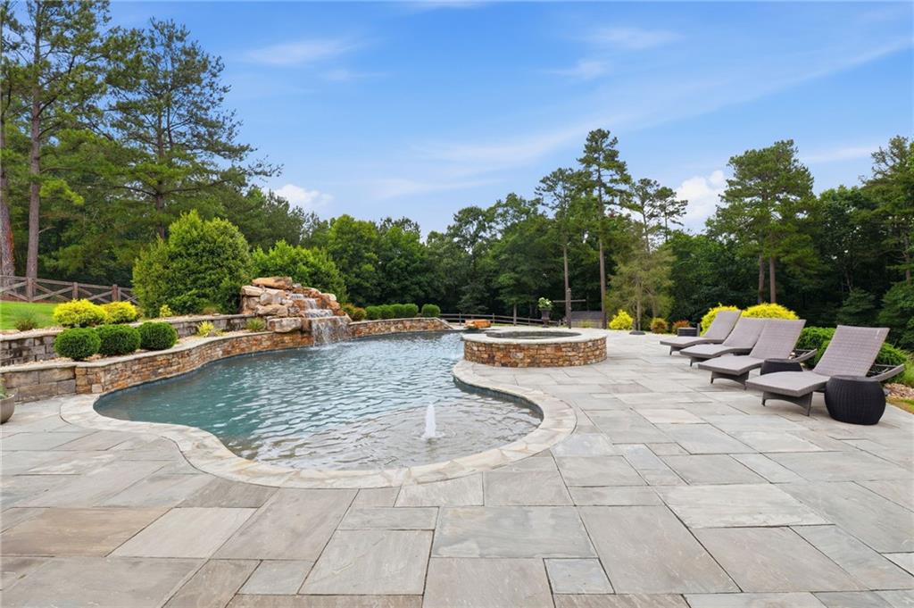 2950 Callie Still Road Lawrenceville, GA 30045 - Photo 47 of 77 a view of a swimming pool with a lounge chairs