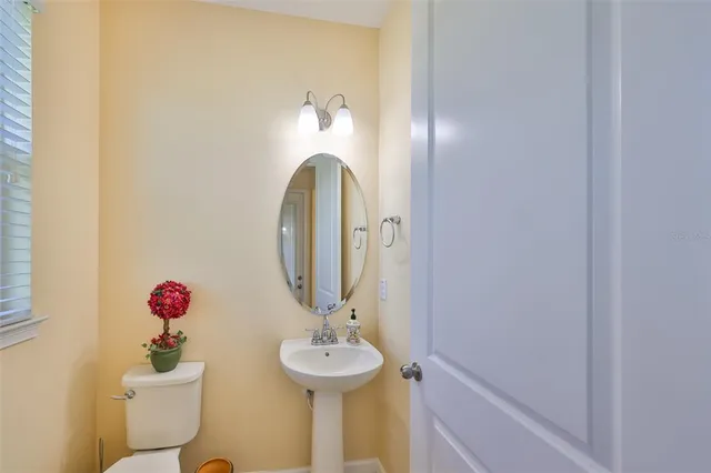 a kitchen with stainless steel appliances a sink stove and wooden floor