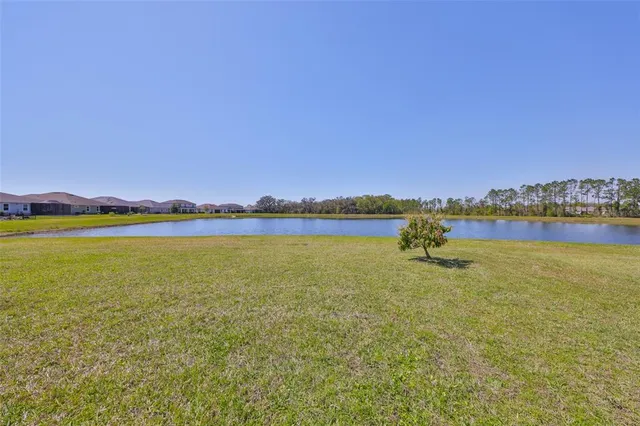 an aerial view of a house with a swimming pool and outdoor seating