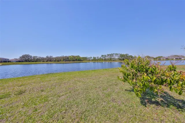an aerial view of a house with a lake view