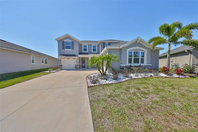 an aerial view of a house with a swimming pool