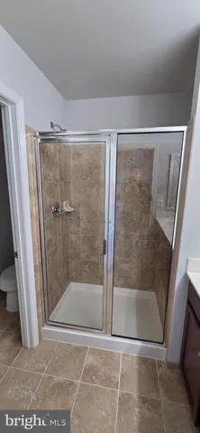 a bathroom with a glass shower door