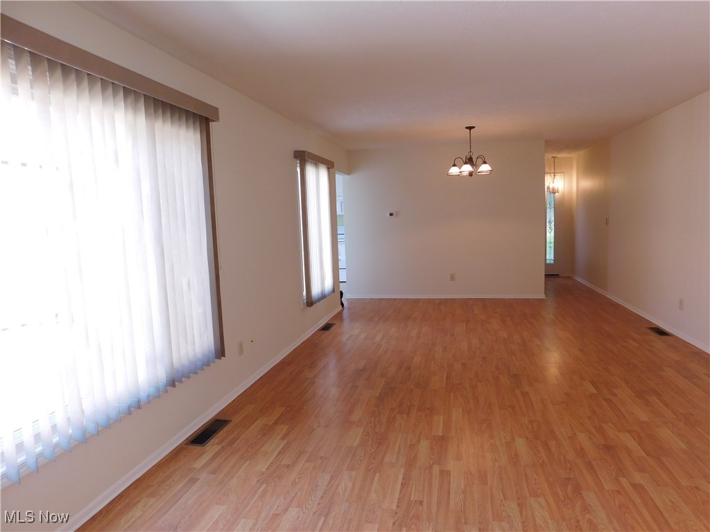 32885 Mills Road North Ridgeville, OH 44039 - Photo 18 of 42 Unfurnished room with a chandelier and light wood-style floors