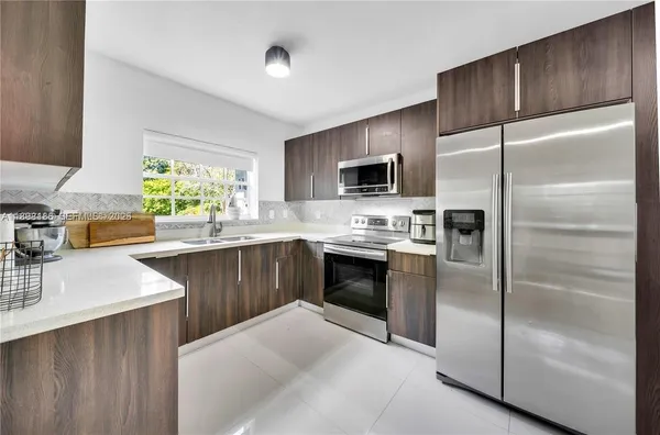 a kitchen with a refrigerator sink and microwave