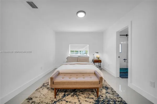 a bedroom with bed and window