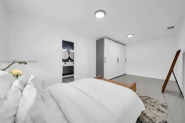 a bedroom with a bed and a mirror