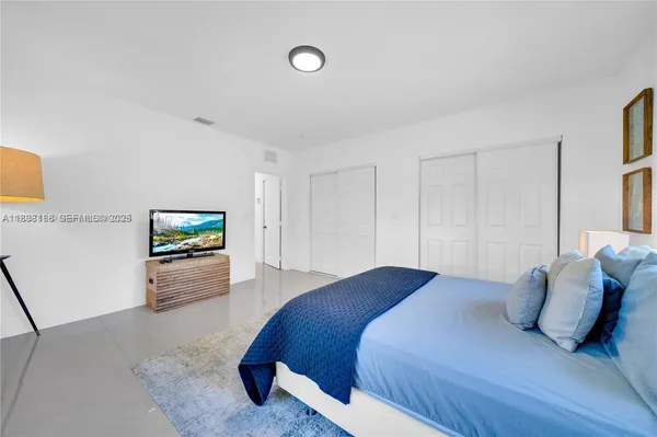 a vase with flowers on a table in a room