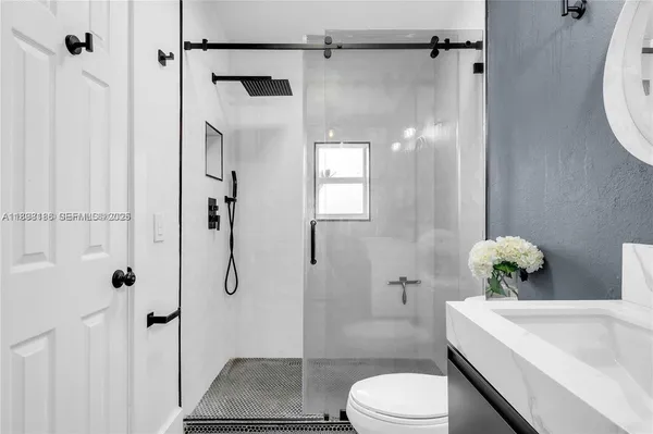 a bathroom with a toilet sink and mirror