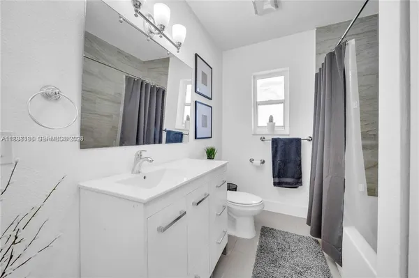 a bathroom with a bathtub and shower