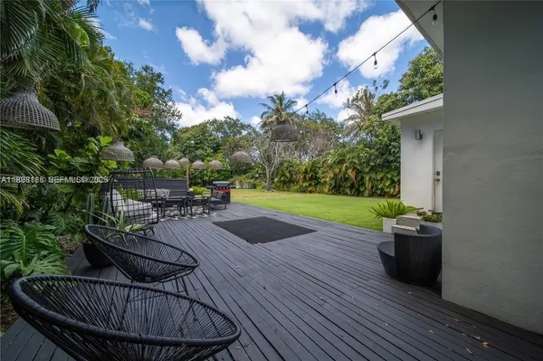 a view of a dinning table and chairs in patio of the house