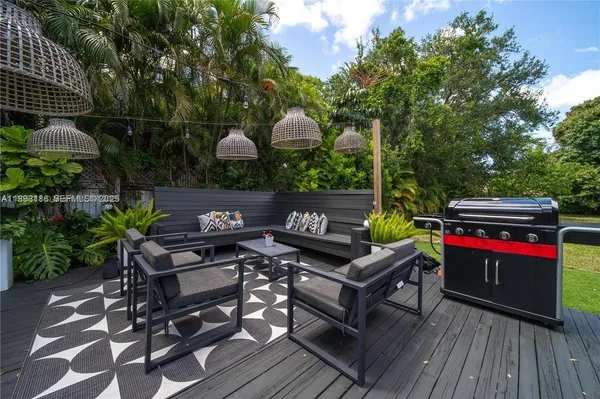 a backyard of a house with table and chairs