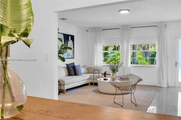 a living room with furniture and a large window