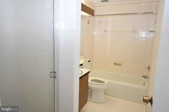 a bathroom with a shower a toilet and a bathtub