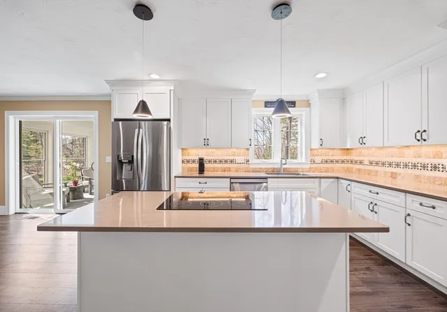 a large bed sitting in a bedroom next to a window