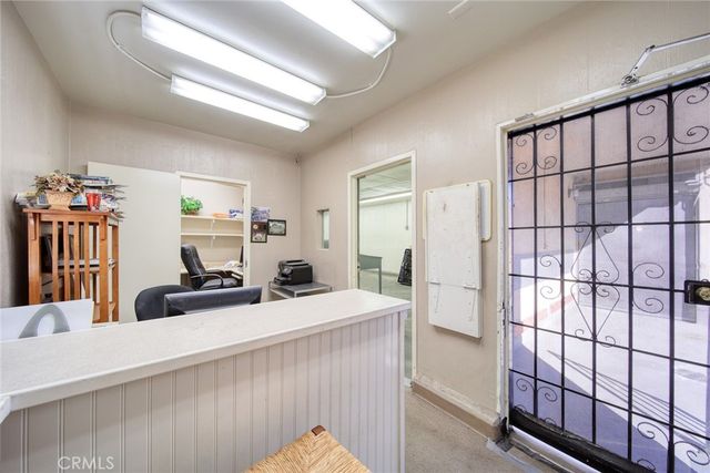 a living room with furniture a flat screen tv and a large window