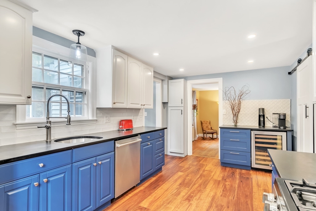 3 White Road Wayland, MA 01778 - Photo 6 of 19 a kitchen with wooden floors and wooden cabinets