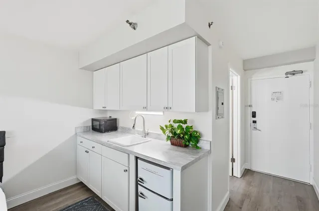 a kitchen with cabinets appliances and a counter space