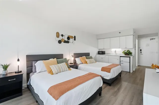 a bedroom with furniture and a large window