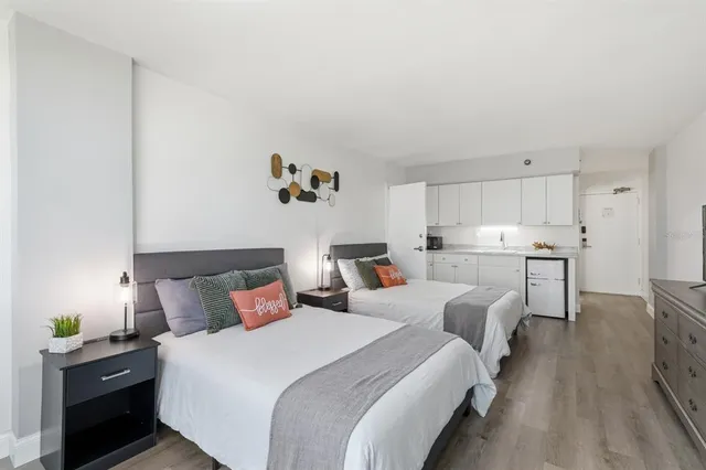 a bedroom with furniture and a flat screen tv