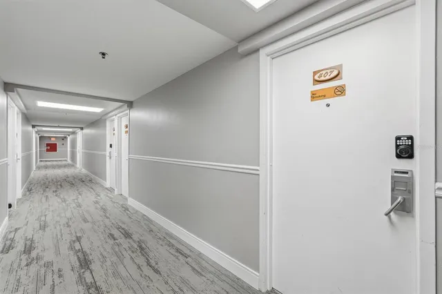 a view of a hallway with wooden floor