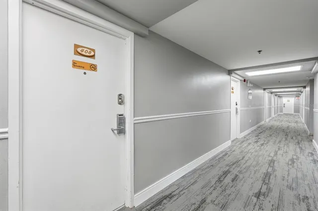 a bedroom with a bed a couch and a flat tv screen on a dresser