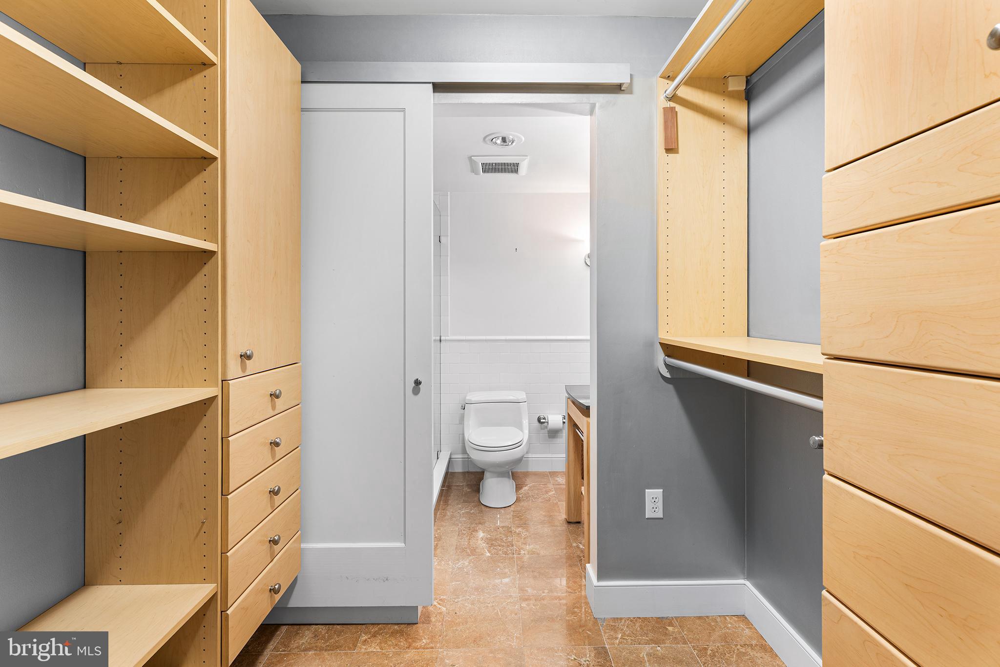 1919 Chestnut Street, Unit 202324 Philadelphia, PA 19103 - Photo 11 of 38 a bathroom with a glass door shower and a toilet