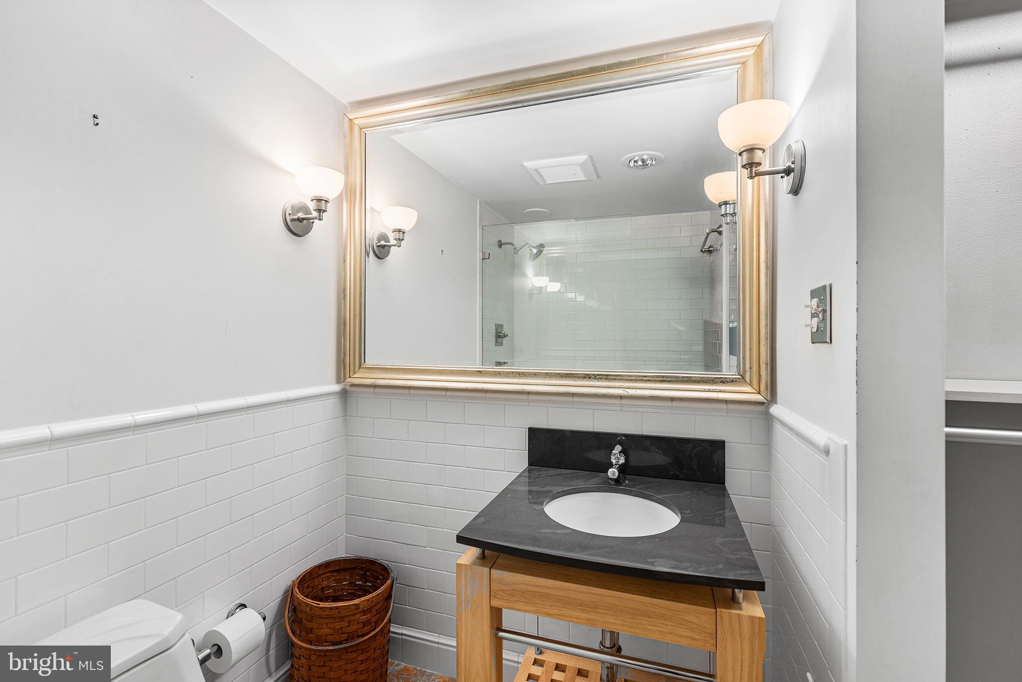 1919 Chestnut Street, Unit 202324 Philadelphia, PA 19103 - Photo 14 of 38 a bathroom with a sink and a mirror