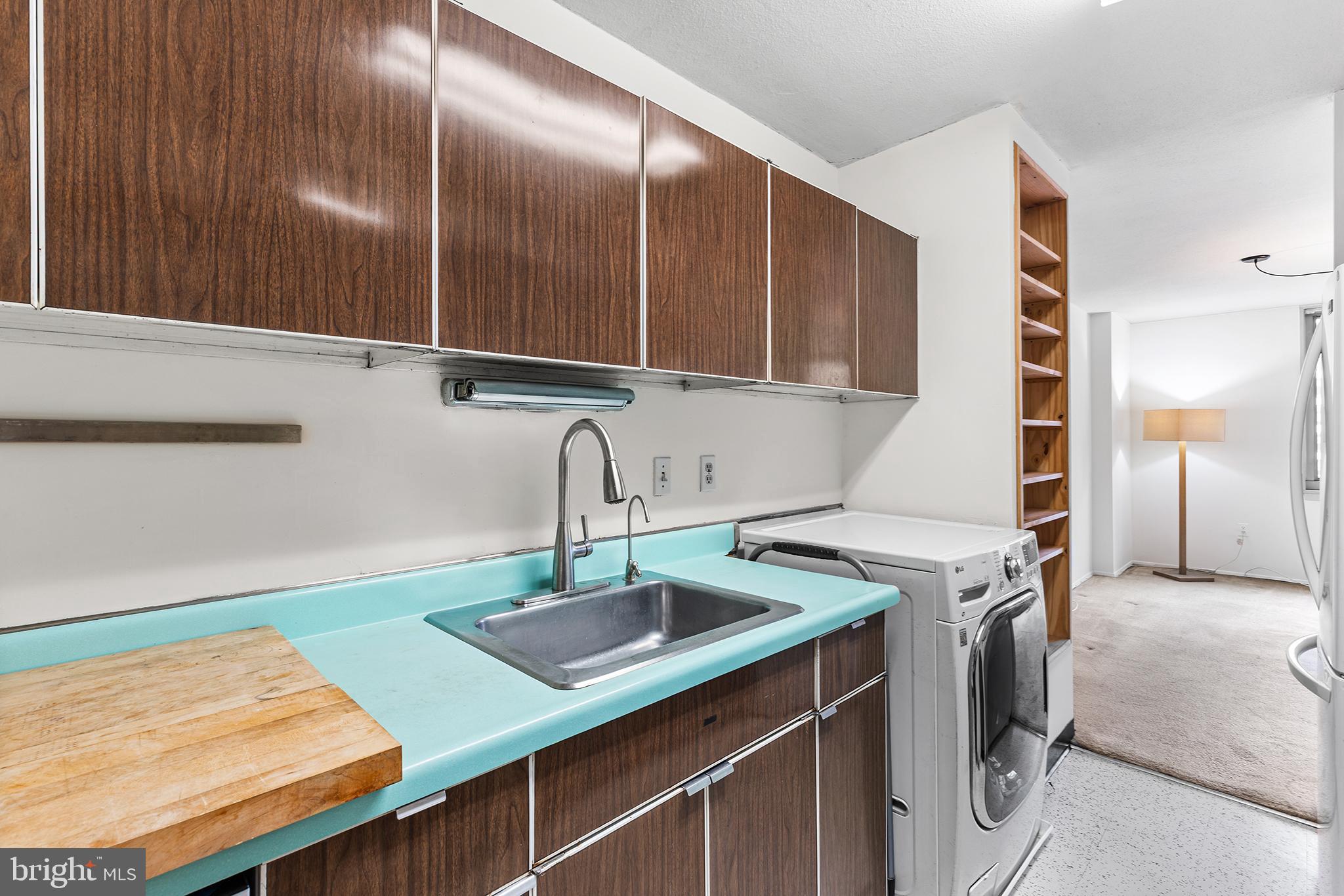 1919 Chestnut Street, Unit 202324 Philadelphia, PA 19103 - Photo 19 of 38 a kitchen with a sink and a refrigerator